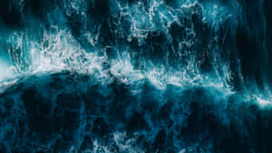 深藍色海水與白色泡沫的撞擊海浪航拍視角。 — iMac 壁紙