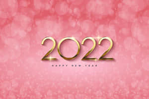 金色2022文字配閃光，在粉紅散景背景上慶祝新年。