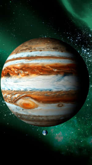 木星與地球，背景是佈滿星星的綠色星雲