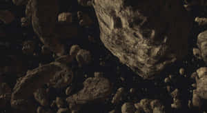 一群岩石小行星漂浮在黑暗的星空中。 — 星際大戰 壁紙