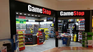 GameStop店舖入口，展示電子遊戲商品和主機。 — 遊戲 壁紙