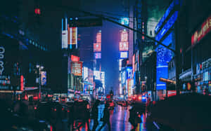 夜晚的時代廣場，霓虹燈和濕漉漉的街道反射著城市的光芒。 — 霓虹城市 壁紙