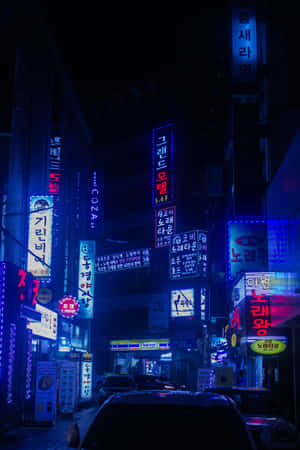 夜晚街道，有發光嘅韓文霓虹招牌同停泊嘅汽車。 — Huawei MatePad 11.5 S (2025) 壁紙