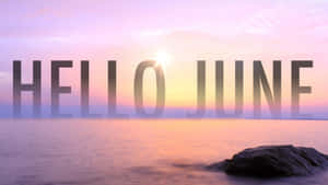 海洋上的日出，帶有 'HELLO JUNE' 文字覆蓋。