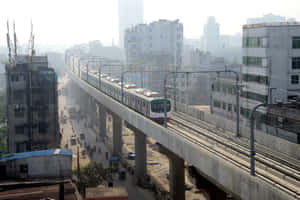 火車在高架軌道上，下方是繁忙的城市街道，有建築物和建築工地