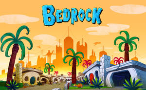 卡通小鎮 Bedrock，有石建築、棕櫚樹和橙色日落天空。 — 卡通 壁紙