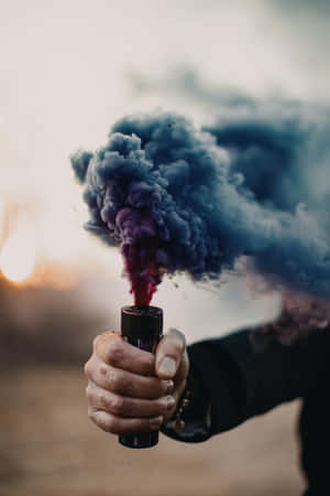 手持煙霧彈在日落時釋放彩色煙霧