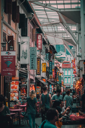 玻璃屋頂下擠滿美食攤檔和發光招牌的街市。