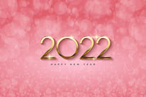 金色2022字樣在粉紅色散景背景上閃爍，用於新年慶祝。
