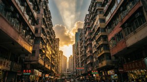 夕陽下的亞洲城市街道，高樓林立，霓虹招牌閃爍。 — 日落 壁紙