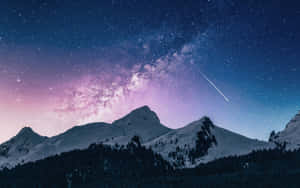在星空下，銀河與流星映襯的積雪山峰。