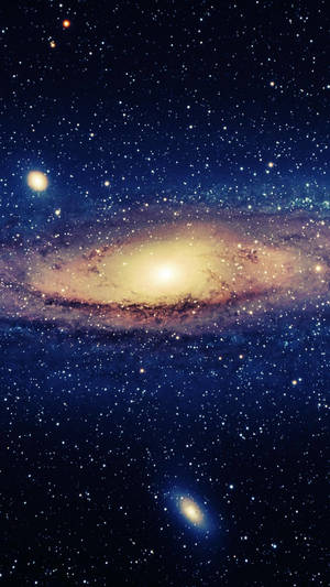 一個螺旋星系，具有明亮的核心和旋轉的旋臂，周圍環繞著無數恆星。 — 太空 壁紙
