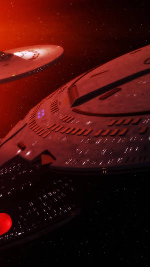 兩艘未來風格的星艦在星空背景下被紅光照亮。 — 星球大戰 iPhone 壁紙