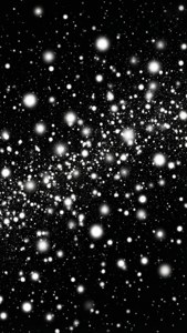 在黑色虛空中漂浮的發光白色粒子場。