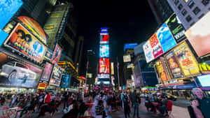 夜晚的時代廣場，明亮的廣告牌和人群。