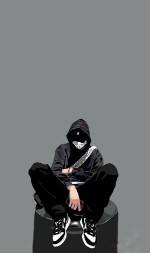 穿著黑色連帽衫和口罩的人坐在灰色背景前的凳子上。