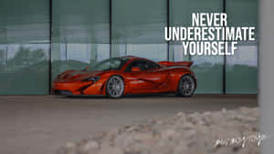 橙色McLaren P1超級跑車在玻璃建築內，帶有勵志文字。