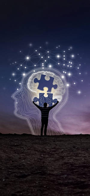 人物手持拼圖碎片，在星空下形成一個發光的大腦。 — 藝術 壁紙