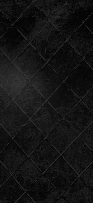 暗色石磚以對角線網格圖案排列，表面帶紋理。 — OnePlus Open 壁紙