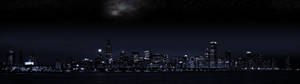 夜晚城市天際線，燈火通明的建築與星空下的水面倒影。 — 夜晚 GIF 壁紙