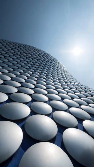 現代建築，在明亮的藍天下擁有彎曲的金屬圓頂。