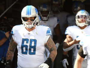 底特律雄獅隊68號美式足球員從隧道走出。 — NFL 美式足球 GIF 壁紙