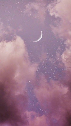 一彎新月在繁星點點的夜空中穿過粉紅雲朵閃耀。