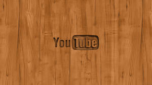 YouTube 標誌嵌入木質表面，木紋清晰可見。