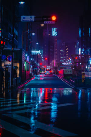 雨中的東京夜晚街道，霓虹燈在濕漉漉的路面上反射。