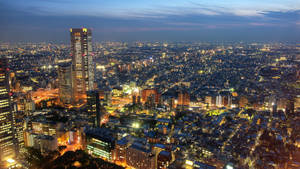 黃昏時分充滿活力的城市鳥瞰圖，建築物和街道燈火通明。