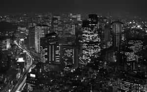黑白鳥瞰圖，夜晚繁華的城市，建築物燈火通明，光跡流動。 — 日本 壁紙