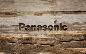 Panasonic 標誌在老化木表面上，可見木紋和磨損。