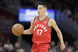身穿紅色Raptors球衣的職業籃球運動員在比賽中運球。 — 阿特蘭大鷹隊 壁紙