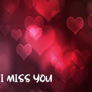 紅色心形形狀柔和發光，帶有訊息 I MISS YOU。 — iPad Air 11 壁紙