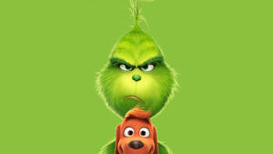 Grinch 和他的狗 Max 在綠色背景上帶著憤怒的表情。 — 電影 GIF 壁紙