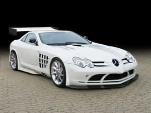 白色 Mercedes-Benz SLR McLaren 跑車在黑色背景的鵝卵石上。