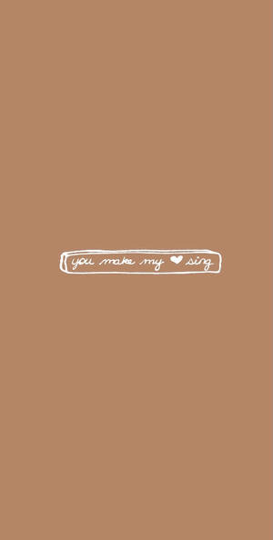 米色背景，上面有白色手寫文字 you make my heart sing。