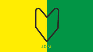 一個風格化的心形標誌分割在黃色和綠色上，帶有「JDM」文字。
