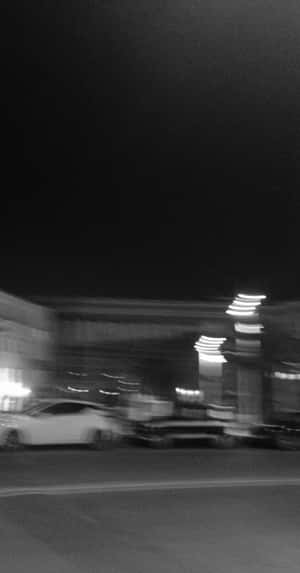 夜間城市街道，汽車和發光招牌的模糊動態。 — 黑白 壁紙