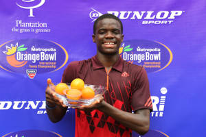 年輕網球選手在Orange Bowl比賽中拿著一碗橙子。