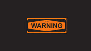 一個警告標誌，橙色背景，黑色文字寫著「THE WARNING」。
