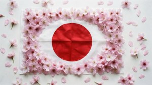 日本國旗被粉紅色櫻花包圍在白色背景上