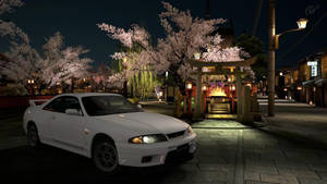 白色跑車在夜晚停在日本櫻花神社附近。
