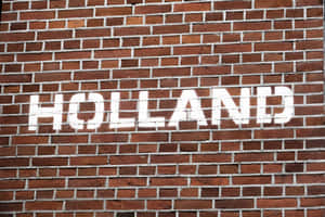 紅磚牆上的白色模板字 holland。