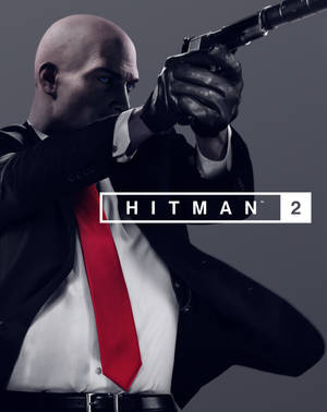 《Hitman 2》遊戲封面，一個穿西裝的光頭男子瞄準手槍。