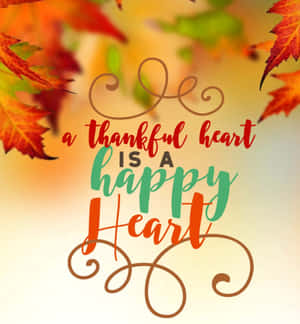 秋葉以彩色手寫體框住了「a thankful heart is a happy heart」這句話。 — Honor Magic V 壁紙