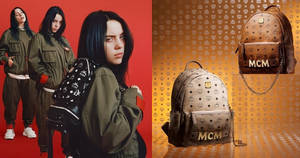 Billie Eilish 身穿橄欖綠色服裝，與 MCM 背包在金色圖案背景上。
