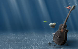 陽光照射的水底場景，有結他和游動的魚。 — 水下 壁紙