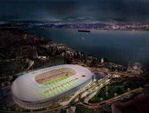 夜晚照亮的Vodafone Arena體育場，旁邊是城市和水道。