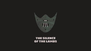 灰色面具，有三個牙齒和眼孔，在黑色背景上帶有白色文字「THE SILENCE OF THE LAMBS」